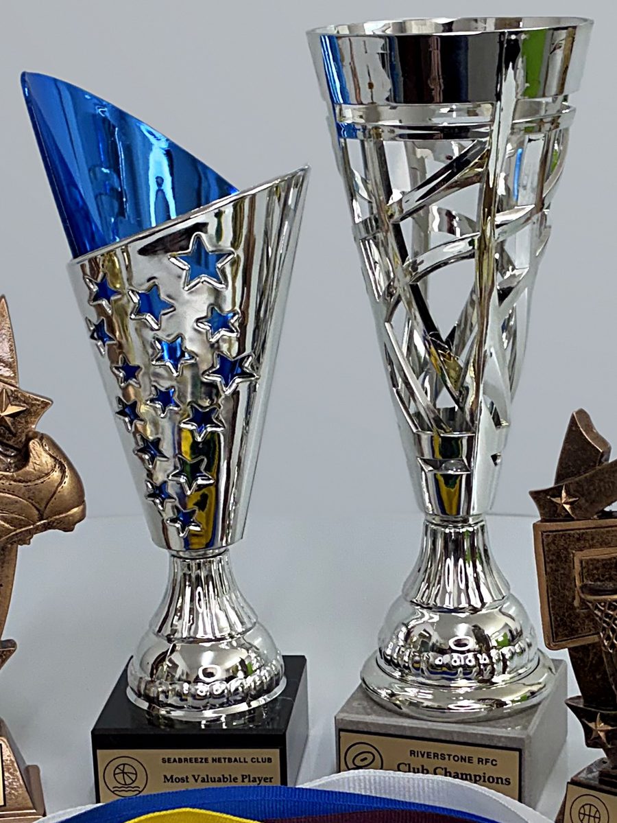 Silver and blue trophy cups on bases